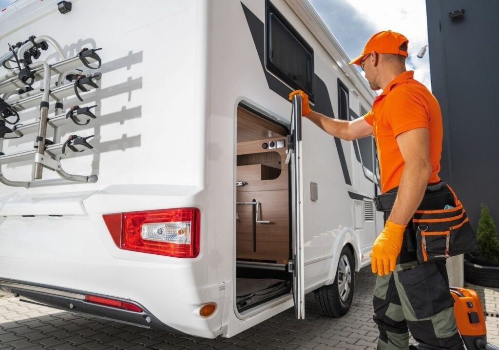 Technician explaining RV inspection results and quote to customer with checklist in hand