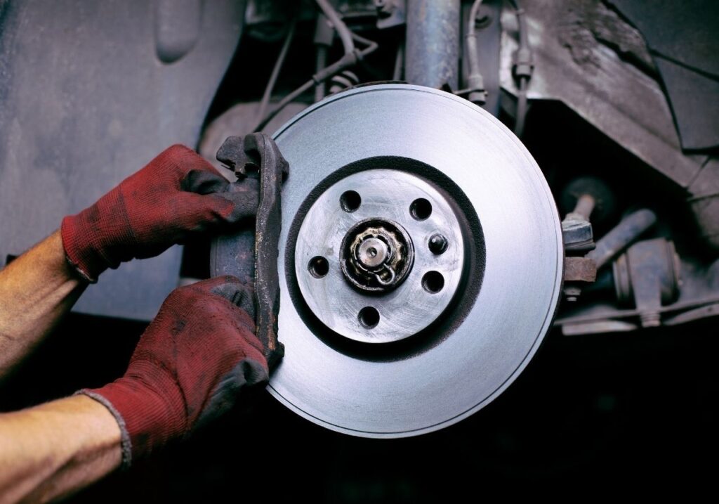 Certified RV technician performing mobile brake service at Hoover Met RV Park