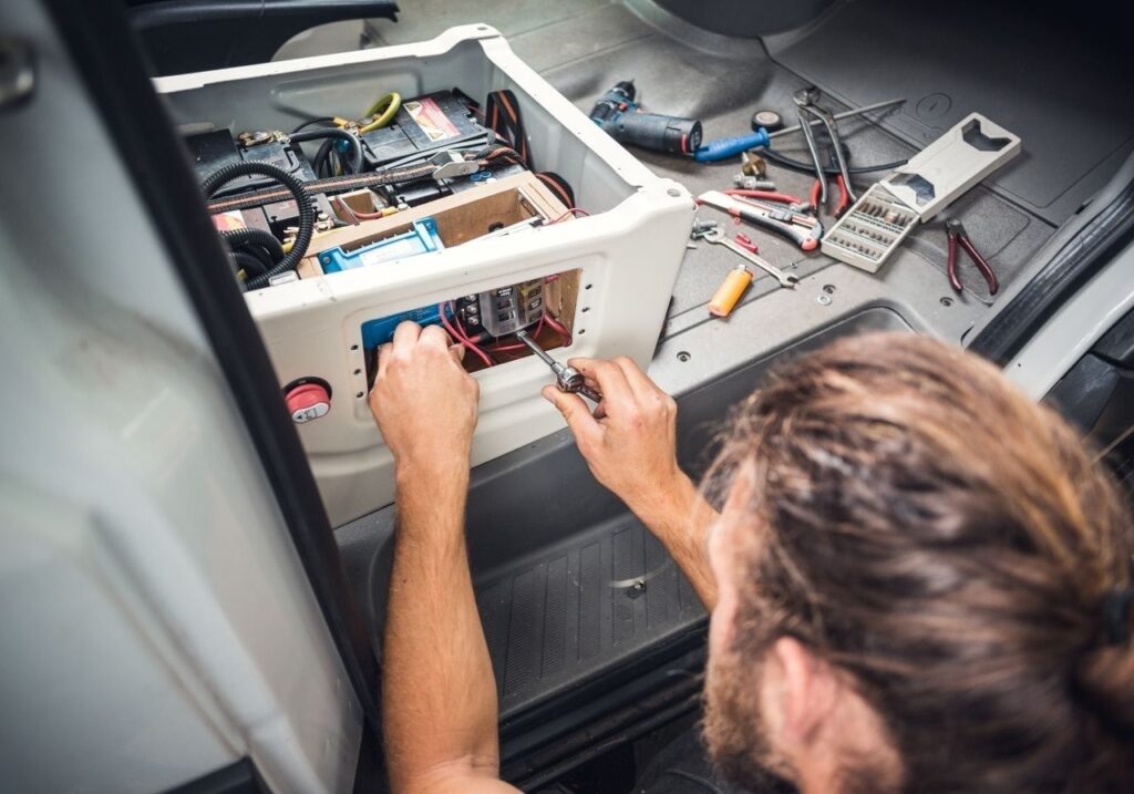 Interior RV breaker panel with wiring exposed during diagnostic electrical inspection