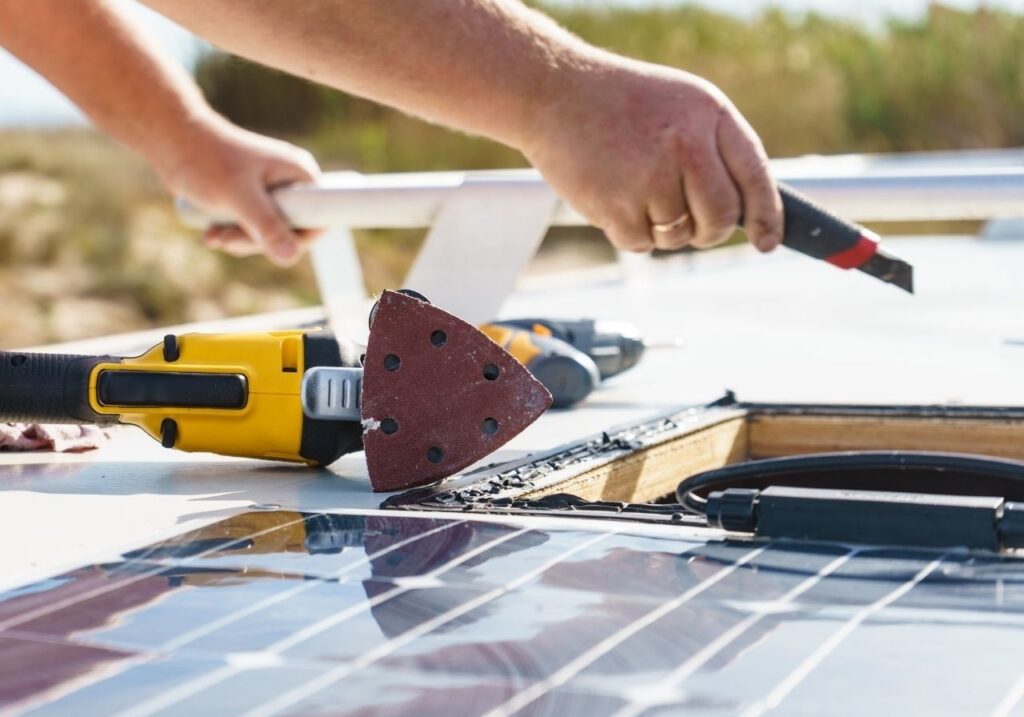 Experienced RV repair technician discussing roof damage with RV owner on-site