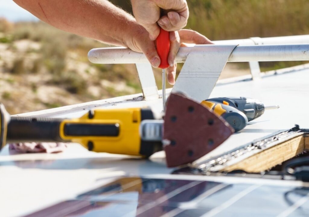 Technician arriving at RV parked in driveway for same-day roof repair in Pelham, AL