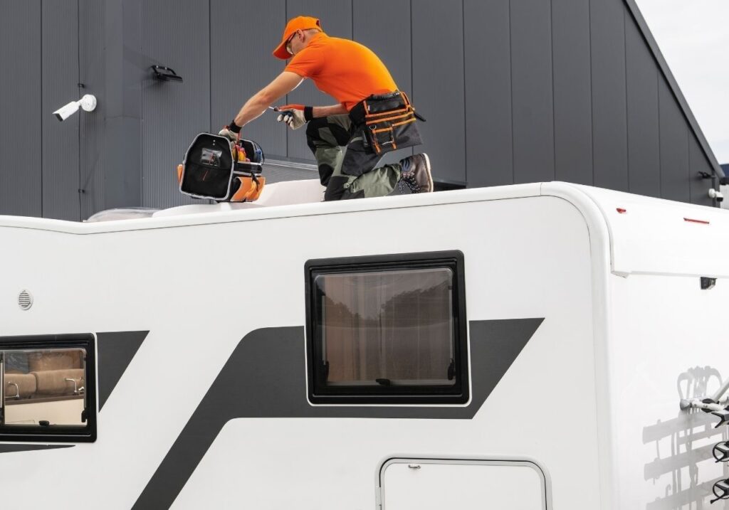 RV parked at Hoover Met Complex RV Park with local technician performing roof maintenance